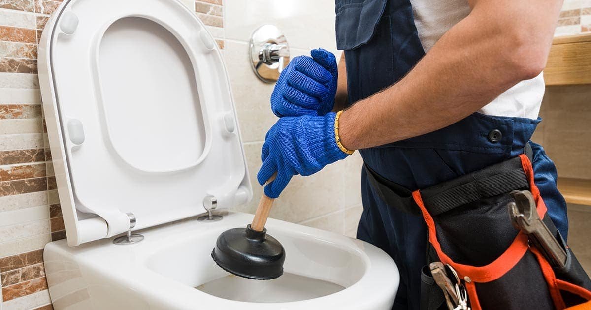 Rocket Ship Plumbing plumber performing toilet repair in Lawrenceville, GA